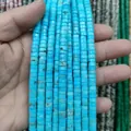 Detailed close-up of sky blue turquoise cylinder beads with natural brown vein textures - Turquoise