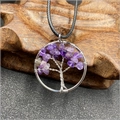 Macro shot of silver wire-wrapped tree of life pendant with purple amethyst stones - Amethyst