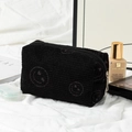 Black corduroy makeup bag featuring an embroidered smiley face with zipper closure - Black Heart-Eye Medium Makeup Bag
