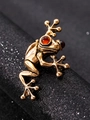Macro shot of a vintage golden frog ring featuring red gemstone eyes on a black stand - Gold Frog Ring (7707)