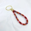 Ethnic bohemian woven fabric wristlet keychain with red pattern and golden metal ring - Red Geometric