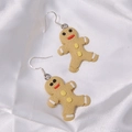 Cartoon gingerbread man drop earrings with yellow finish and festive detailing - Resin Gingerbread Man