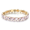 Detailed macro view of heart-shaped pink crystals set in gold-tone metal prongs for women - Pink