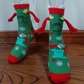 Christmas magnetic socks in green featuring Santa Claus and snowman patterns - Green Santa Claus