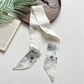 Elegant crane pattern twilly scarf on wooden tray with minimalist white background - Spring Vitality