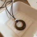 Close-up of vintage resin ring pendant with wooden beads on a brown suede cord - 15# Necklace - Brown..