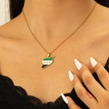 Detail view of Syria map necklace pendant with flag colors and gold chain on neck - 18K Gold Syria Style