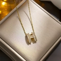 Mini gold-plated necklace with crystal-encrusted H pendant on jewelry box - 8938 Golden Full Diamond H