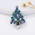 Detailed close-up of a blue Christmas tree brooch with colorful gems and white pearls - Drip Oil Green Christmas Tree