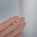 Minimalist 925 sterling silver cylindrical stud earrings held in hand for size display - Small Cylinder / Silver