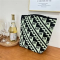 Close-up of a black and green geometric knit tote bag placed on a rustic wooden table - 5 Staircase Pattern Black Green