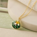 Close-up of shell pendant with green and yellow enamel and small starfish detail - Enamel Starfish Pearl Style / Green