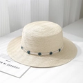 Detail of a beige straw boater hat featuring a white band with blue evil eye beads - One Size / Off White