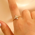Golden flower ring with zircon stones on female model hand for elegant styling - Four-petal Flower Marquise Zircon Twisted Rope Style (12214)