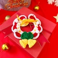 Detailed view of a handmade crochet Christmas wreath ornament in a festive red gift box - Bell with White Pompoms Bib