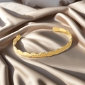Golden open bangle with wavy edges and hammered texture on elegant silk background - f37 Wave Hammered Style / Gold