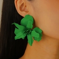 Close-up of oversized green 3D floral earrings featuring textured layered petals on model - Green