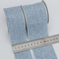 Blue faux burlap Christmas ribbon with 63mm width shown on measuring scale - Customizable Width