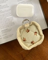 Floral quilted storage pouch for AirPods with metal ring on a rustic wooden desk - Fruit Pattern