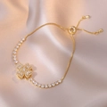 Elegant gold clover bracelet with white zircons on a champagne satin background - Gold Heart Bracelet (TS0196) / Gold