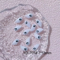 Close-up of YD-701 white resin ghost nail charms with black smiles on pink background - YD-701# Smiling Ghost