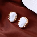 Detail of vintage gold textured earrings with white resin and sparkling rhinestones - Gold-White