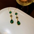 Detailed close-up of emerald drop earrings with gold floral zircon accents - Pear-Shaped Tassel Style (40#)