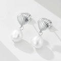 Detailed view of silver shell stud earrings with hanging white freshwater pearls - 925 Silver / White