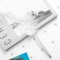 Creative white feather ballpoint pen with sleek silver metal barrel on a stylish magazine - Silver (White Feather)
