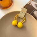 Pair of yellow elastic hair ties with large ball charms for girls on display card - Yellow