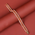 Elegant gold-plated bracelet featuring red and white rhinestones on a red background - Gold+Red