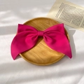 Detailed close-up of a large pink satin bow hair clip on a wooden tray with soft lighting - Two-Layer Bow Spring Clip / Rose Red
