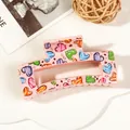 Detail of pink rectangular hair claw clip with colorful heart patterns on a stylish background - 8.5cm Heart Print - Style L Pink