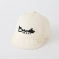 Creamy white baby sun hat with black embroidered letters and soft brim detail - 50cm (1-3 Years) / NESOE Embroidery - Off White