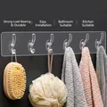Transparent 6-hook wall rack with adhesive backing showing bath accessories and towels - Acrylic 6-Hook Coat Rack