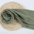 Bean green chiffon hijab scarf with pearls and delicate hem on a woven mat - 92
