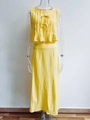 Detail of yellow cotton linen set featuring pleated sleeveless top with bow tie accents - Yellow Set