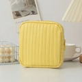Macro detail of bright yellow PU leather pouch with vertical stitching and zipper - Yellow