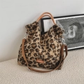 Detail of plush leopard print tote bag with orange rope handles and adjustable brown strap - Brown Lamb Velvet Leopard