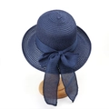Detail view of navy blue straw sun hat with large mesh bow on a wooden display stand - M (56-58cm) / Navy Blue