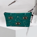 Detailed shot of dark green makeup bag with golden mystic celestial patterns on white stand - Dark Green Gold Celestial