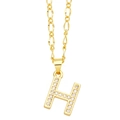 Macro detail of gold Figaro chain and capital letter H pendant with micro-set zircons - Letter H