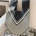 Knitted tote bag with black, white and grey striped patterns on a storage rack - Vertical V-shaped Black