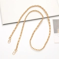 Detail of a gold metal chain interwoven with beige leather and secure lobster clasps - Gold