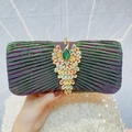 Deep iridescent pleated evening clutch featuring a golden peacock rhinestone buckle - Purple