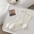 Creamy white crew socks with vertical ribbing and delicate lettuce edge trim for women - Pure White