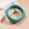 Detailed view of wide resin bangle with green marble texture and gold foil accents - Blue