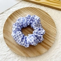 Blue and white plaid scrunchie hair tie on a minimalist wooden tray display - Dark Purple Plaid