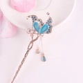 Golden butterfly hair pin with blue gemstones and flowing tassels on floral base - Gold Blue Butterfly Gem Tassel (FZ022)