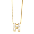 Macro detail of gold-plated letter H pendant with baguette cubic zirconia stones - Gold H